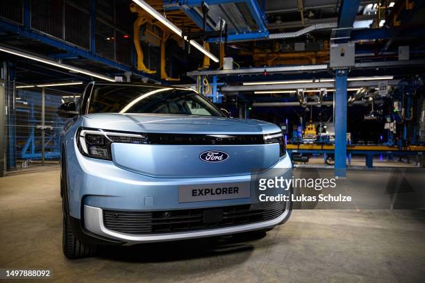 Electric Ford Explorer is seen as the German Chancellor Olaf Scholz visits the electric car production line at the Ford automobile factory on June...