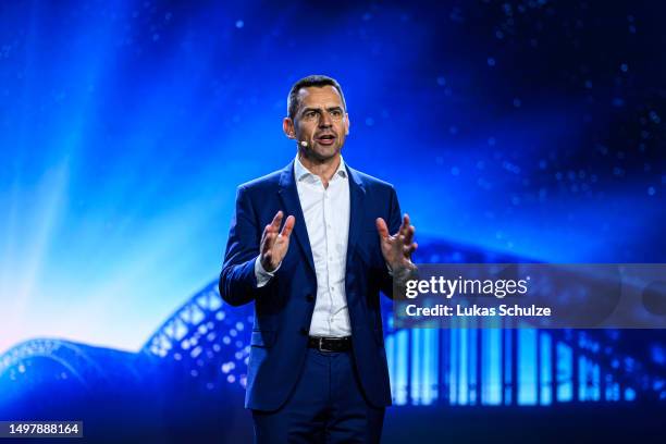 Martin Sander, Chair Ford-Werke GmbH, speaks on stage at the electric car production line at the Ford automobile factory on June 12, 2023 in Cologne,...