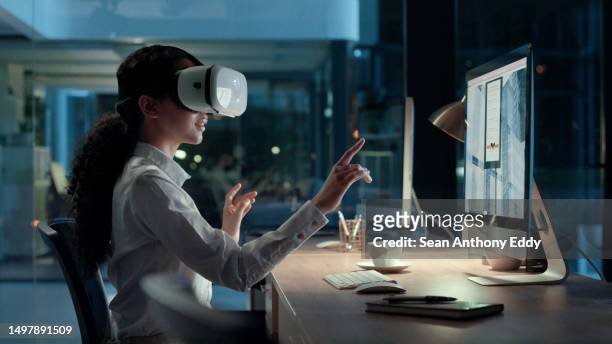 vr headset and goggles of a young woman testing a new tech project on a office computer. modern technology creator test futuristic 3d virtual meeting. female digital worker talking to people online - computer equipment stock pictures, royalty-free photos & images