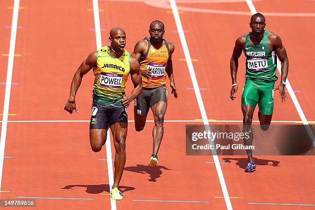 Asafa Powell of Jamaica, Churandy Martina of Netherlands and Obinna Metu of Nigeria compete in the Men's 100m Round 1 Heats on Day 8 of the London...