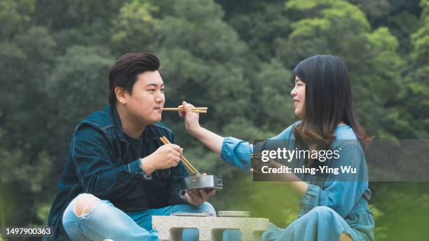 tea garden guided tour, and couple having lunch time in the tea garden - asian couple having hi tea stockfoto's en -beelden