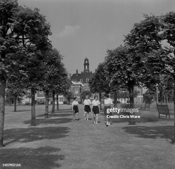 Schoolgirls with tennis racquets in the grounds of Henrietta Barnett School, in the Central Square of Hampstead Garden Suburb in the borough of...