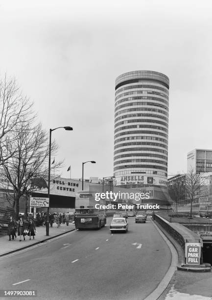 The Rotunda, a 25-storey cylindrical building, an advert for local brewery Ansells around the base, rising above the Bull Ring Shopping Centre in...