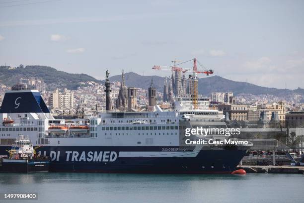 Emblematic buildings of Barcelona such as the Sagrada Familia, the Barcelona Cathedral and the Columbus monument are seen behind a Grimaldi ferry...