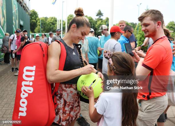 Maria Sakkari of Greece signs autographs for fans after winning the Women's Singles Round of 32 match against Xiyu Wang of China during Day One of...