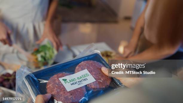 closeup young asian women friends arriving from supermarket with grocery bag and unpacking plant-based meal in kitchen at home at night. lifestyle healthy food eating enjoying natural life concept. - alternativ bildbanksfoton och bilder