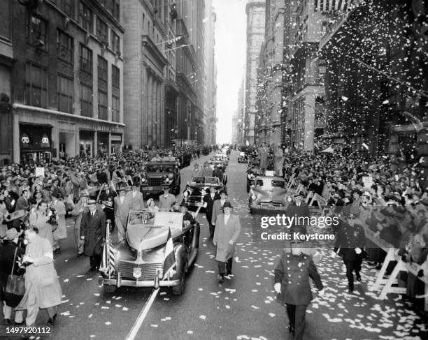 Dutch Royals Juliana of the Netherlands and Prince Bernhard of Lippe-Biesterfeld are showered with ticker tape as their procession passes along...