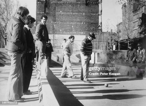 Italian-Americans playing bocce on a clay court with boarded ends and sides, on the Lower East Side of Manhattan, New York City, New York, November...