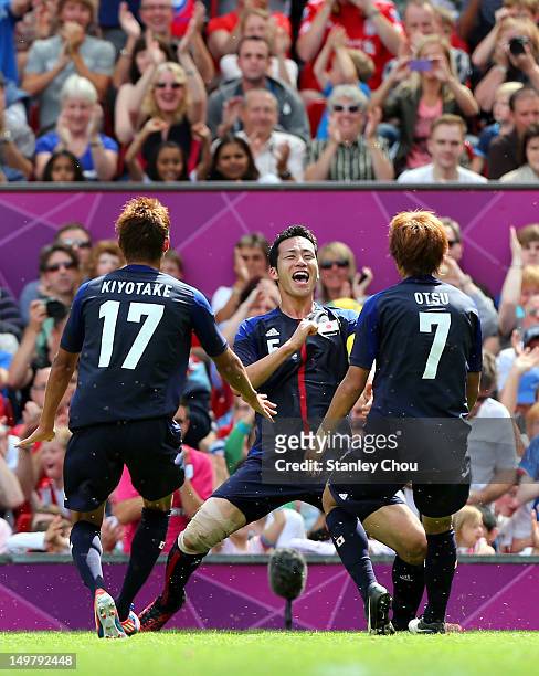 Maya Yoshida of Japan celebrate after scoring with Hiroshi Kiyotake and Yuki Otsu greet him during the Men's Football Quarter Final match between...