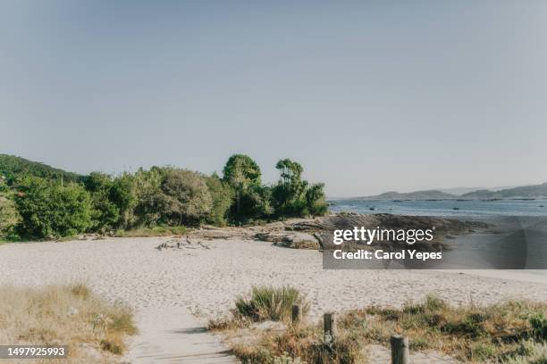 beautiful scenery of a calm sandy beach in galicia, spain - private beach stock pictures, royalty-free photos & images