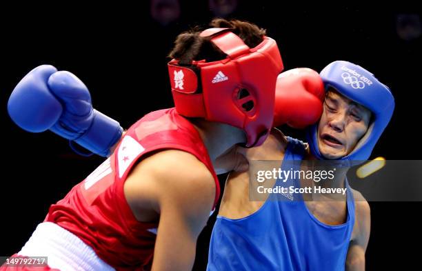Birzhan Zhakypov of Kazakhstan in action with Mark Barriga of Philippines during the Men's Light Fly (46-49kg_ Boxing on Day 8 of the London 2012...