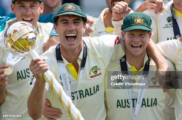 Patrick Cummins and Steven Smith of Australia hold the ICC World Test Championship mace and celebate with their team mates after Austraila become the...