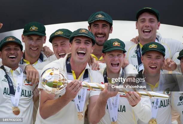 Patrick Cummins and Steven Smith of Australia hold the ICC World Test Championship mace and celebate with their team mates after Austraila become the...