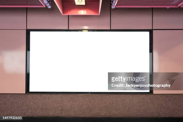 a subway station wall is covered with blank billboard advertising banner media. - poster subway stock-fotos und bilder
