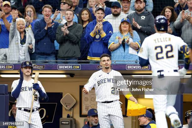 Willy Adames congratulates Christian Yelich of the Milwaukee Brewers after a home run in the second inning against the Oakland Athletics at American...