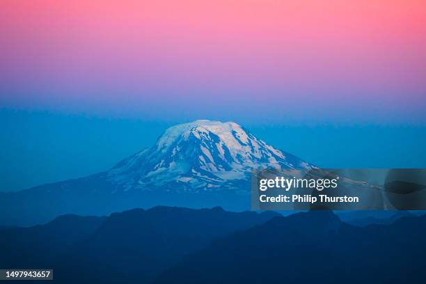 mount rainier with pastel bands of colour at dusk with snow on top - mt rainier national park stock pictures, royalty-free photos & images