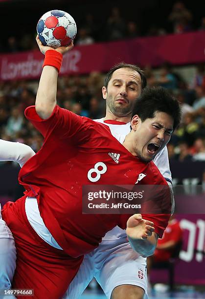 Junggeu Park of Korea shoots while defended by Alem Toskic of Serbia during the Men's Preliminaries Group B match between Korea and Serbia on Day 8...