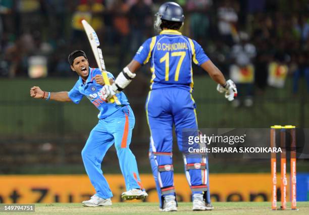 Indian cricketer Ashok Dinda celebrates after dismissing Sri Lankan cricketer Dinesh Chandimal during the fifth and final one-day international match...