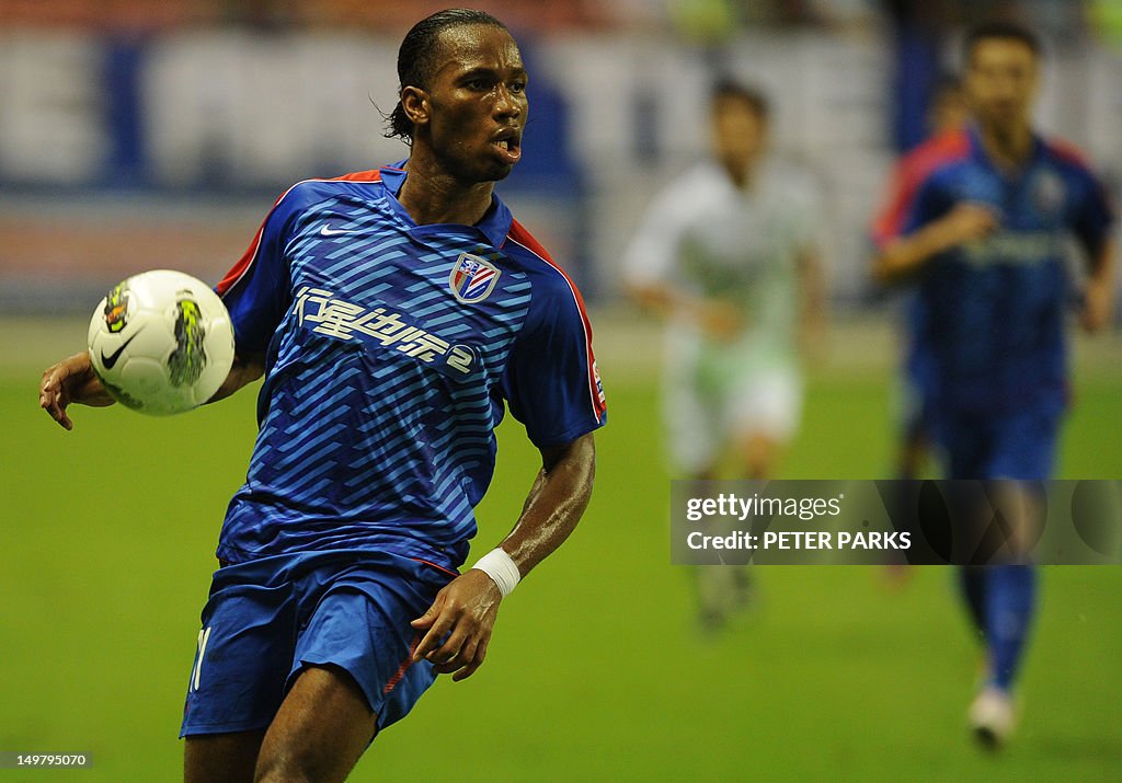 Didier Drogba (L) plays for Shanghai She