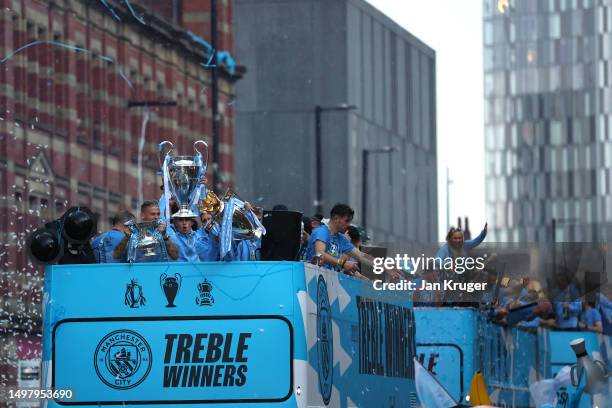 General view as players of Manchester City celebrate on the Open-Top Bus, which read "Treble Winners" as fans line the streets during the Manchester...