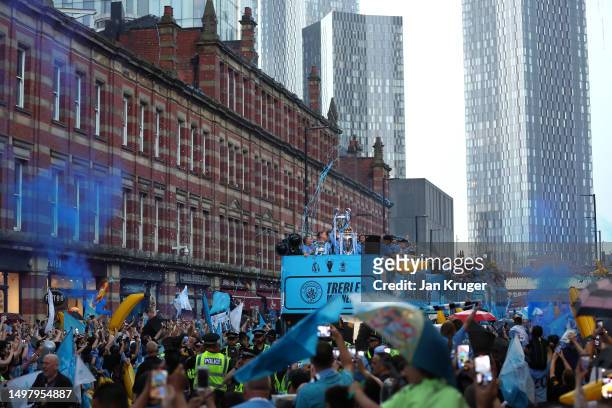 General view as players of Manchester City celebrate on the Open-Top Bus, which read "Treble Winners" as fans line the streets during the Manchester...