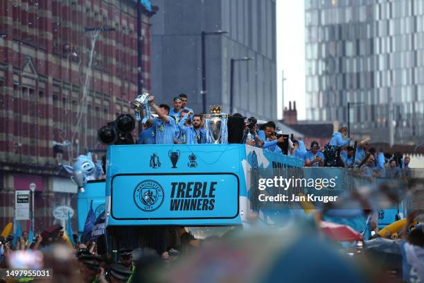 General view as players of Manchester City celebrate on the Open-Top Bus, which read "Treble Winners" as fans line the streets during the Manchester...