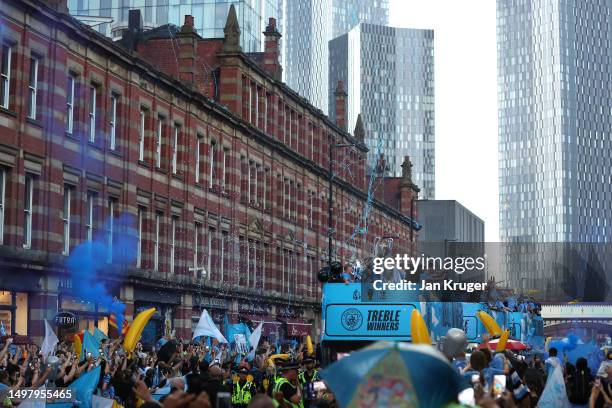 General view as players of Manchester City celebrate on the Open-Top Bus, which read "Treble Winners" as fans line the streets during the Manchester...