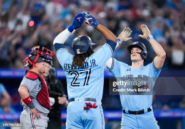 Matt Chapman of Toronto Blue Jays celebrates his home run with Vladimir Guerrero Jr. #27 against the Minnesota Twins during the fifth inning in their...