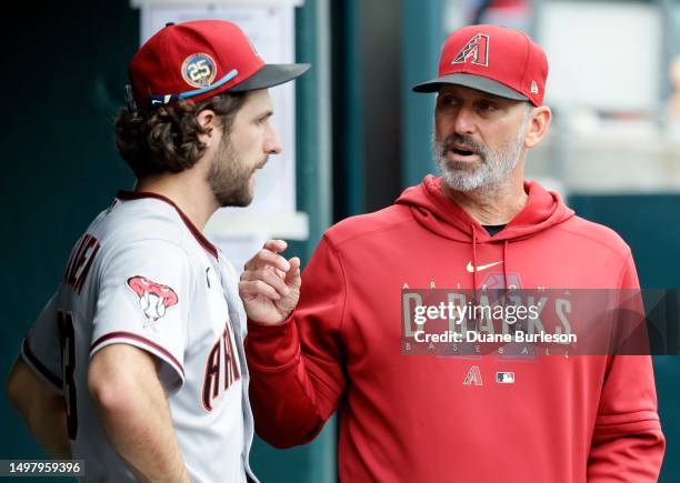 Manager Torey Lovullo of the Arizona Diamondbacks talks with starting pitcher Zac Gallen during the seventh inning of a game against the Detroit...