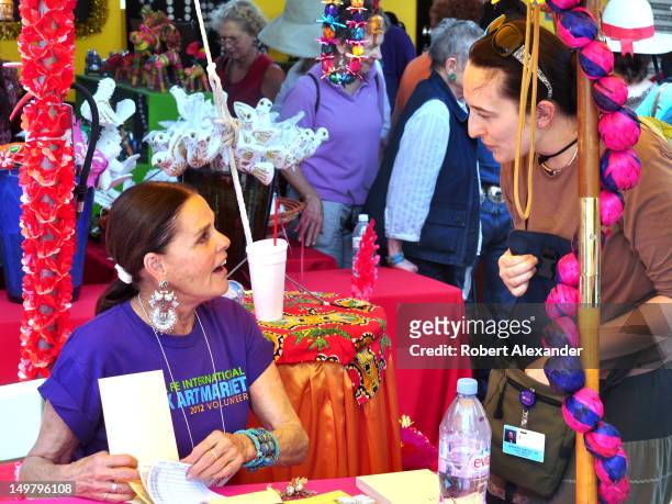 Actress Ali MacGraw, left, talks with a friend at the 2012 Santa Fe International Folk Art Market. MacGraw was a volunteer salesperson at the annual...