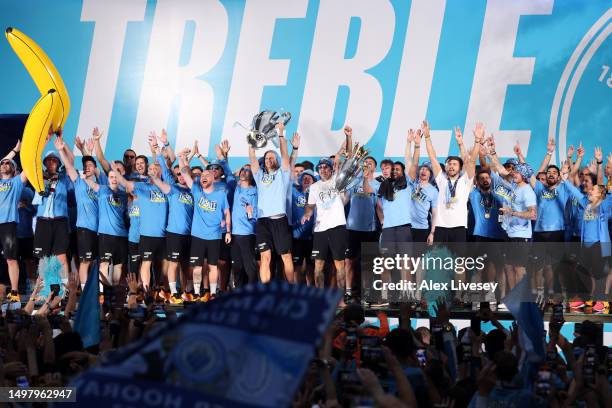 General view as the word "Treble" is seen on the stage in St Peter's Square as Erling Haaland lifts the UEFA Champions League Trophy and Ederson and...