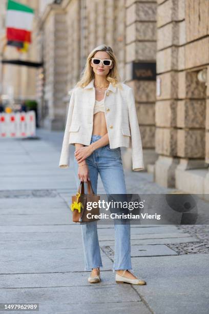 Mandy Bork wears denim jeans Agolde, white jacket & cropped top Zara, sunglasses Linda Farrow, necklace Van Cleef & Arpels, shoes Chanel, brown bag...