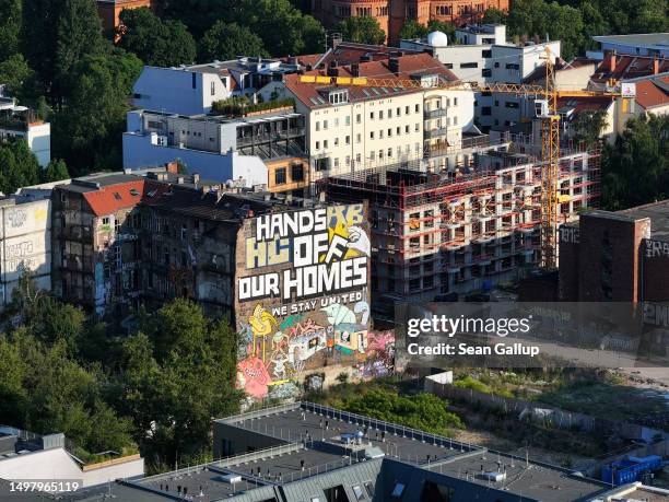 In this aerial view a new residential building stands under construction next to the Koepi autonomous housing project on June 12, 2023 in Berlin,...