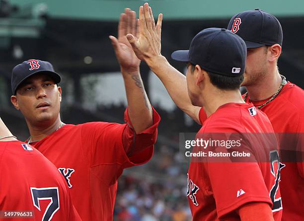 Boston Red Sox starting pitcher Felix Doubront congratulates Boston Red Sox center fielder Jacoby Ellsbury for a fine defensive catch in the first...