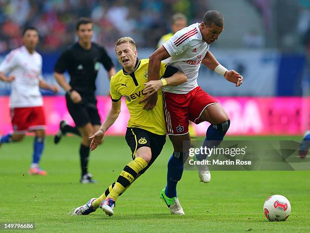 Jeffrey Bruma of Hamburg and Marco Reus of Dortmund battle for the ball during the LIGA total! Cup Semi final match between Hamburger SV and BVB...