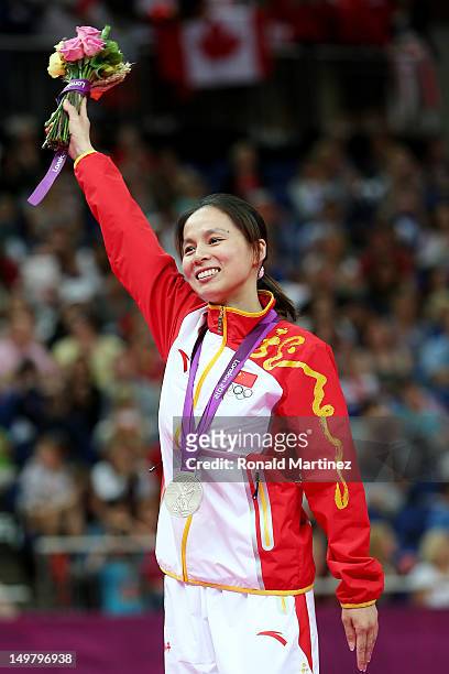Silver medalist Shanshan Huang of China stands with her medal after Trampoline on Day 8 of the London 2012 Olympic Games at North Greenwich Arena on...
