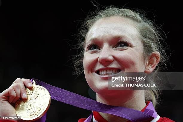 Canada's Rosannagh MacLennan celebrates with her gold medal after the women's trampoline final of the artistic gymnastics event of the London 2012...