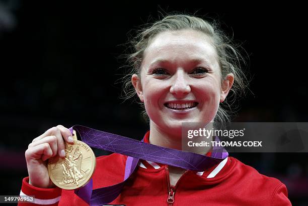 Canada's Rosannagh MacLennan celebrates with her gold medal after the women's trampoline final of the artistic gymnastics event of the London 2012...