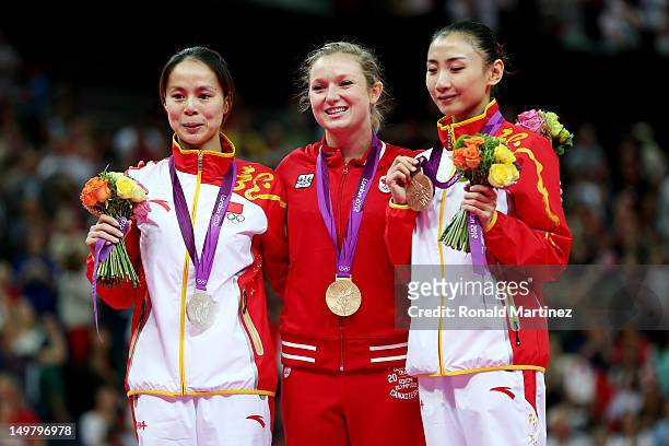 Silver medalist Shanshan Huang of China, gold medalist Rosannagh Maclennan of Canada, and bronze medalist Wenna He of China stand on the medal stand...