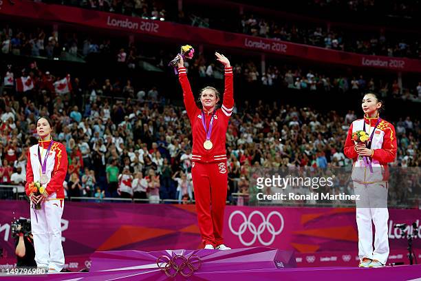Silver medalist Shanshan Huang of China, gold medalist Rosannagh Maclennan of Canada, and bronze medalist Wenna He of China stand on the medal stand...