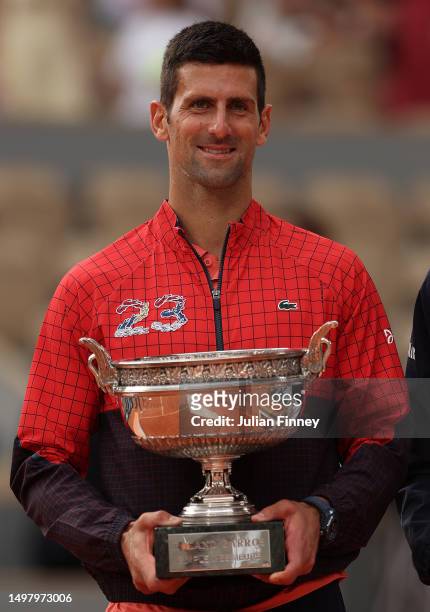 Novak Djokovic of Serbia celebrates with the winners trophy after victory against Casper Ruud of Norway in the Men's Singles Final match on Day...