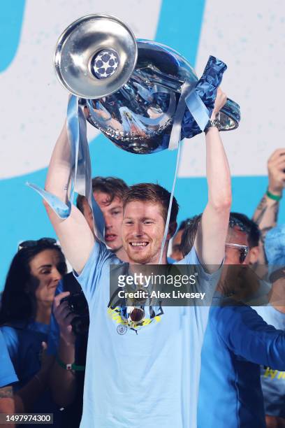 Kevin De Bruyne of Manchester City celebrates on stage with the UEFA Champions League Trophy in St Peter's Square during the Manchester City trophy...