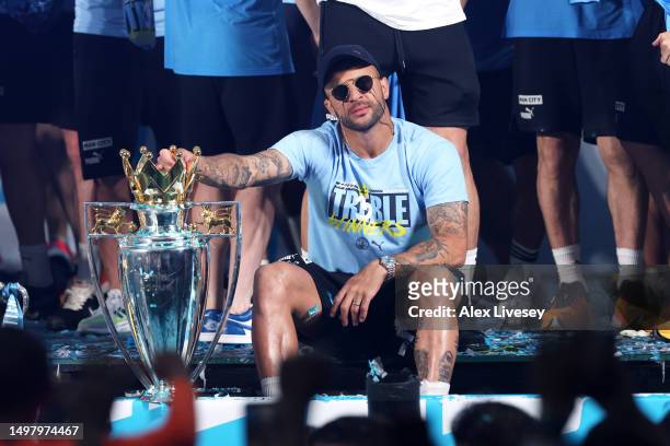Kyle Walker of Manchester City celebrates with the Premier League Trophy on stage in St Peter's Square during the Manchester City trophy parade on...