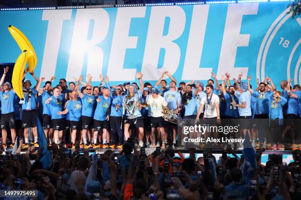 General view as players of Manchester City celebrate on stage in front of the "Treble" banner as Erling Haaland celebrates with the UEFA Champions...