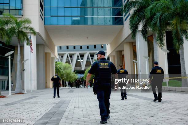 Department of Homeland Security police walk around the Wilkie D. Ferguson Jr. United States Federal Courthouse before the arraignment of former...