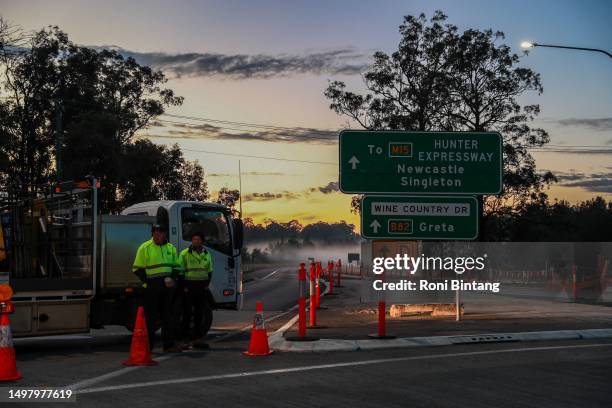 People stand by a roadblock near the site of a bus crash on June 13, 2023 in Cessnock, Australia. A horrific bus crash in the Hunter Valley killed at...