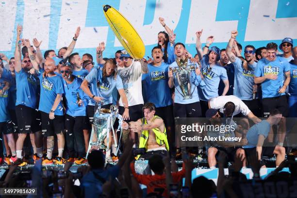 General view as players of Manchester City celebrate in front the "Treble" banner on stage in St Peter's Square as Erling Haaland of Manchester City...