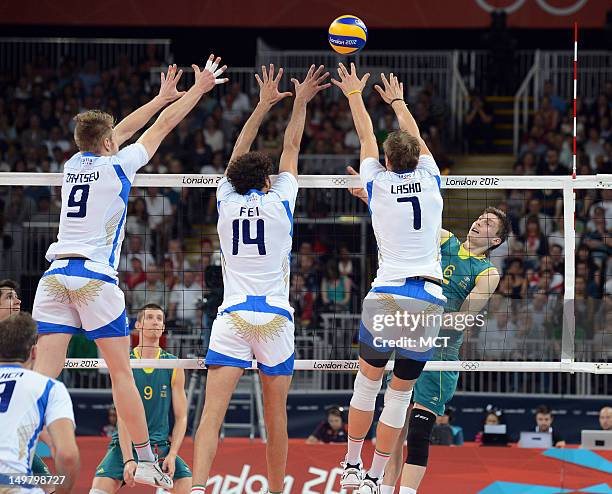 Italy's Ivan Zaytsev , Alessandro Fei and Michal Lasko attempt to block a shot by Australia's Igor Yudin during fourth-set action at Earls Court...