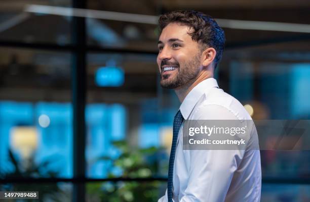 portrait of a business man in the office. his office can be seen in the background - looking away stock pictures, royalty-free photos & images