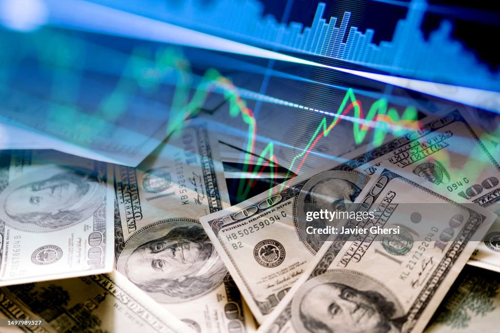 Cash dollar bills and stock market indicators